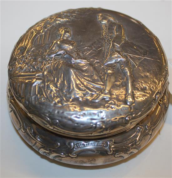 Continental silver circular box & cover, embossed with a couple in a garden, B. M. Landeck 1909 Chester import mark